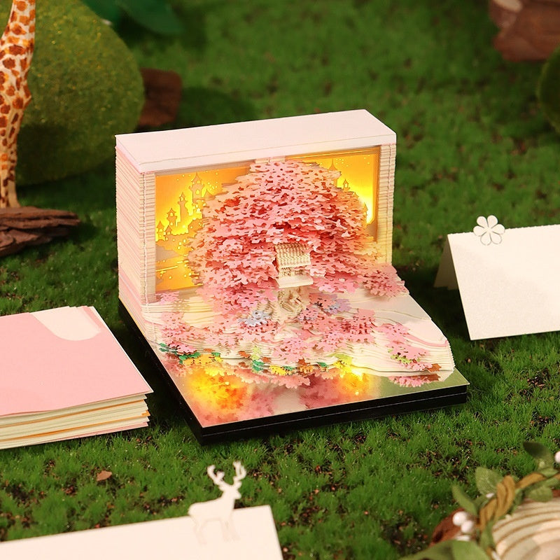 Four stages of the 3D treehouse paper sculpture reveal – from block to finished scene