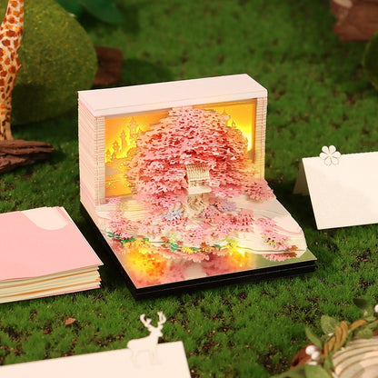Four stages of the 3D treehouse paper sculpture reveal – from block to finished scene